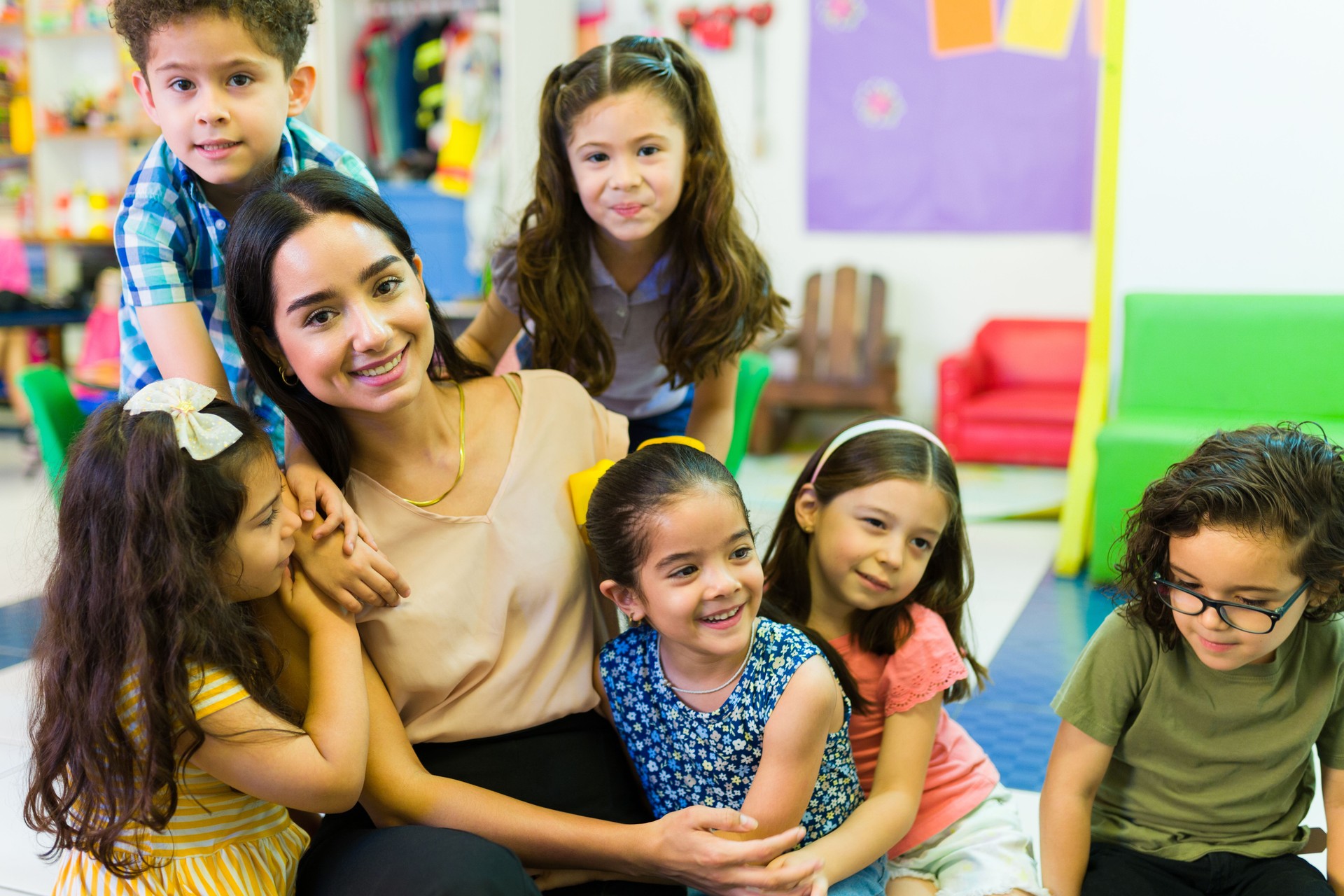Portrait, group and kids with smile at school for education, learning and knowledge with hug. Student, children or face with happiness in classroom for study, scholarship or childhood development